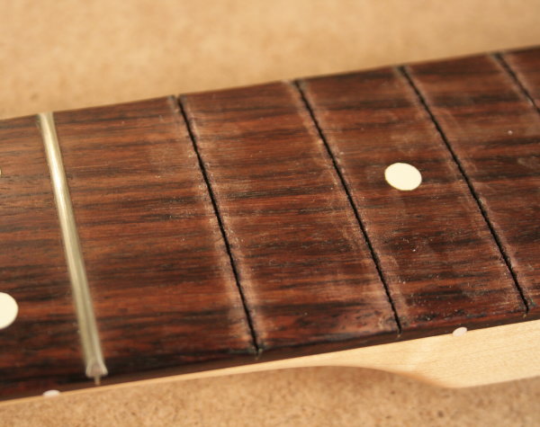 Fretboard with marks after tower pincers
