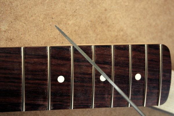 Round the fret ends with homemade fret end dressing file