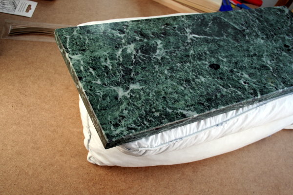 A slab of marble with a pillow underneath to absorb the blows